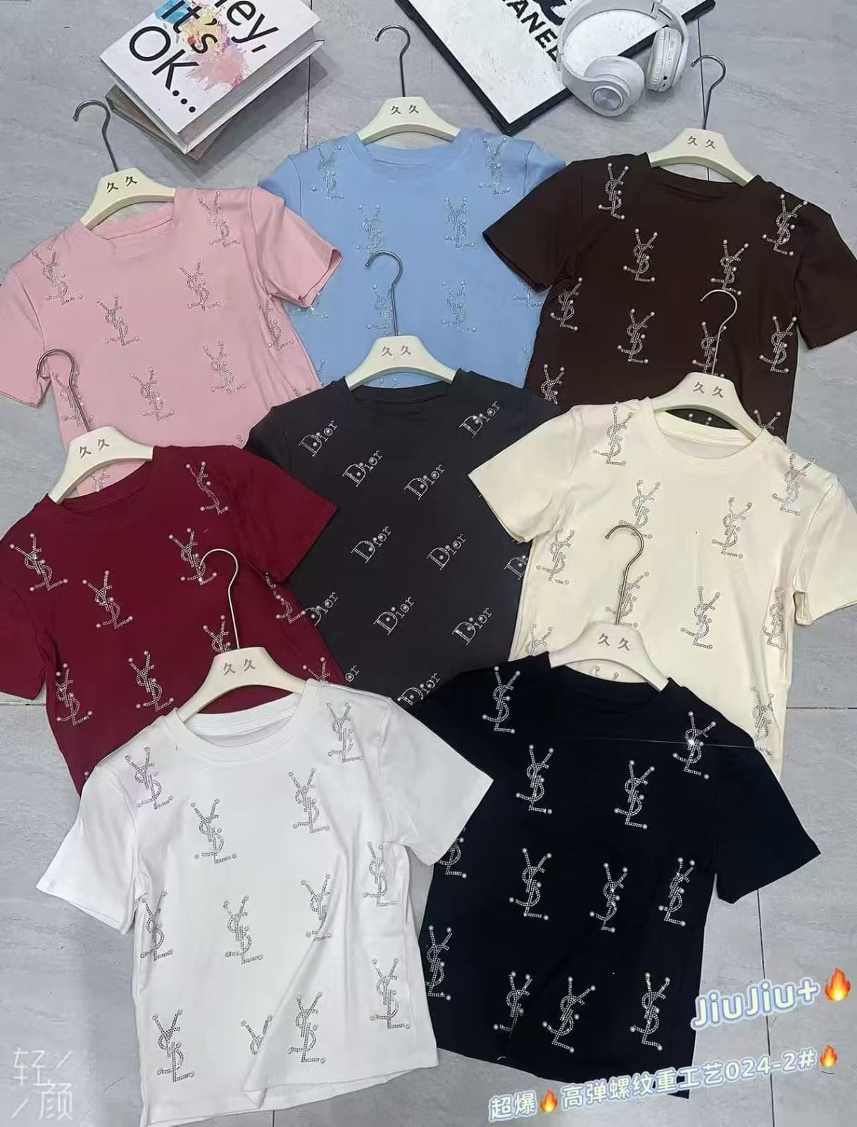 Women's rhinestone embellished logo print crop T-shirts in 8 colours — pink, sky blue, dark brown, black, maroon, cream, white — displayed on hangers