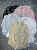 Women's schiffli cutwork embroidered floral shirt in 5 colours — black, blush pink, sky blue, white and beige — displayed on hangers on marble floor