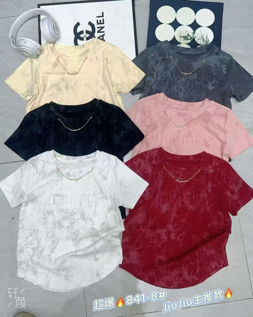 Women's acid wash chain detail T-shirts in 6 colours — butter yellow, charcoal grey, black, blush pink, white and wine — laid flat on floor