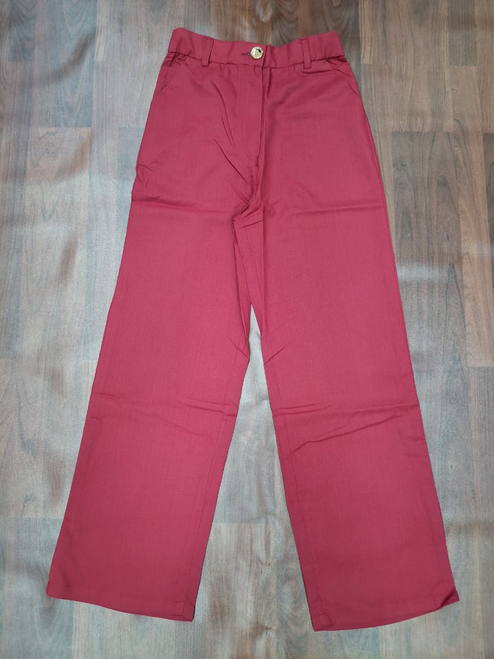 Women's high-waist wide-leg palazzo pants in dusty rose with gold button detail by Miss Kapachi