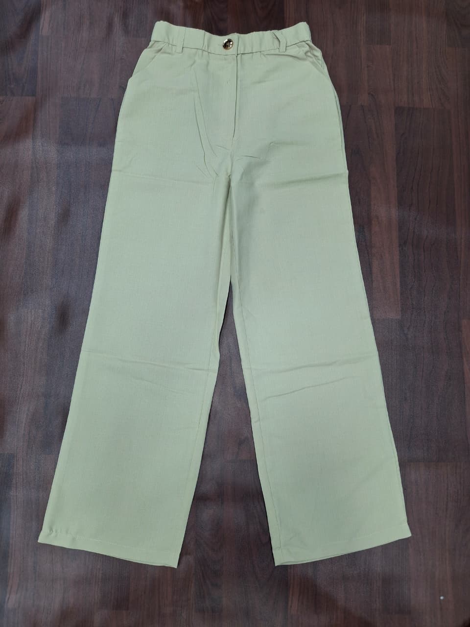 Women's high-waist wide-leg palazzo pants in mint green with gold button detail by Miss Kapachi