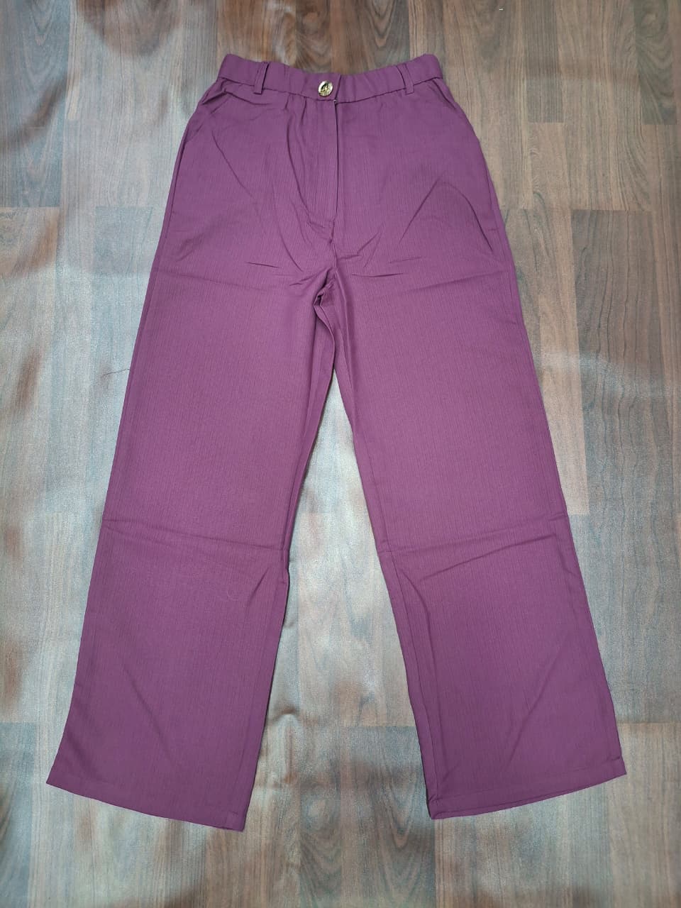 Women's high-waist wide-leg palazzo pants in mauve purple with gold button detail by Miss Kapachi