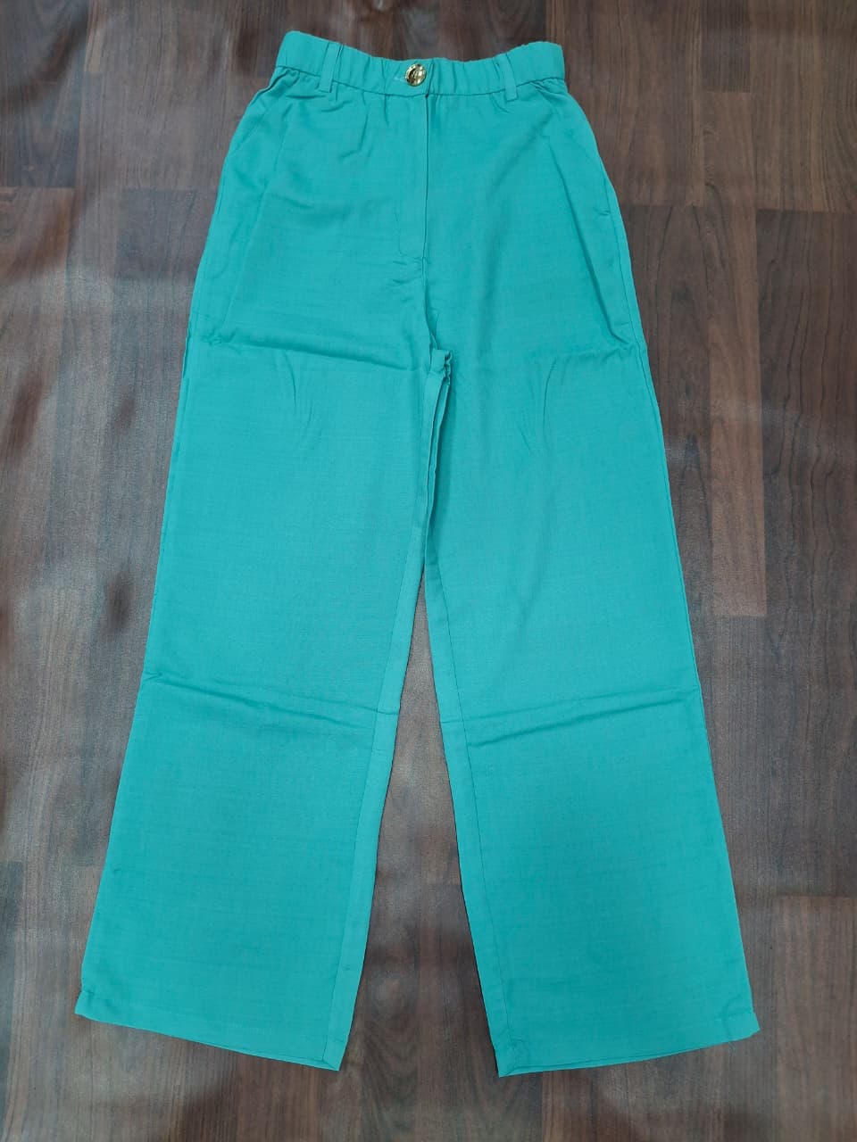 Women's high-waist wide-leg palazzo pants in teal with gold button detail by Miss Kapachi