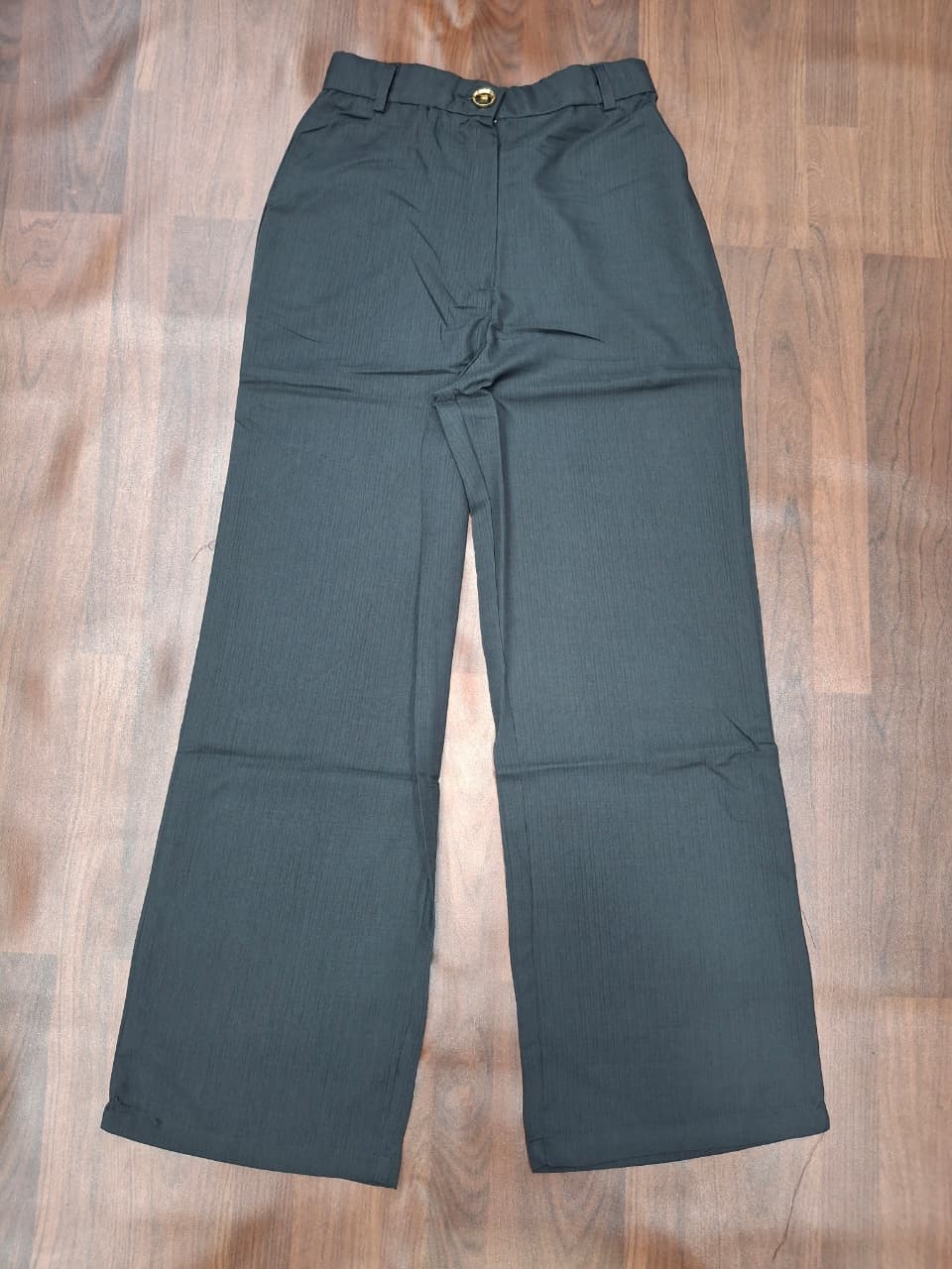Women's high-waist wide-leg palazzo pants in bottle green with gold button detail by Miss Kapachi