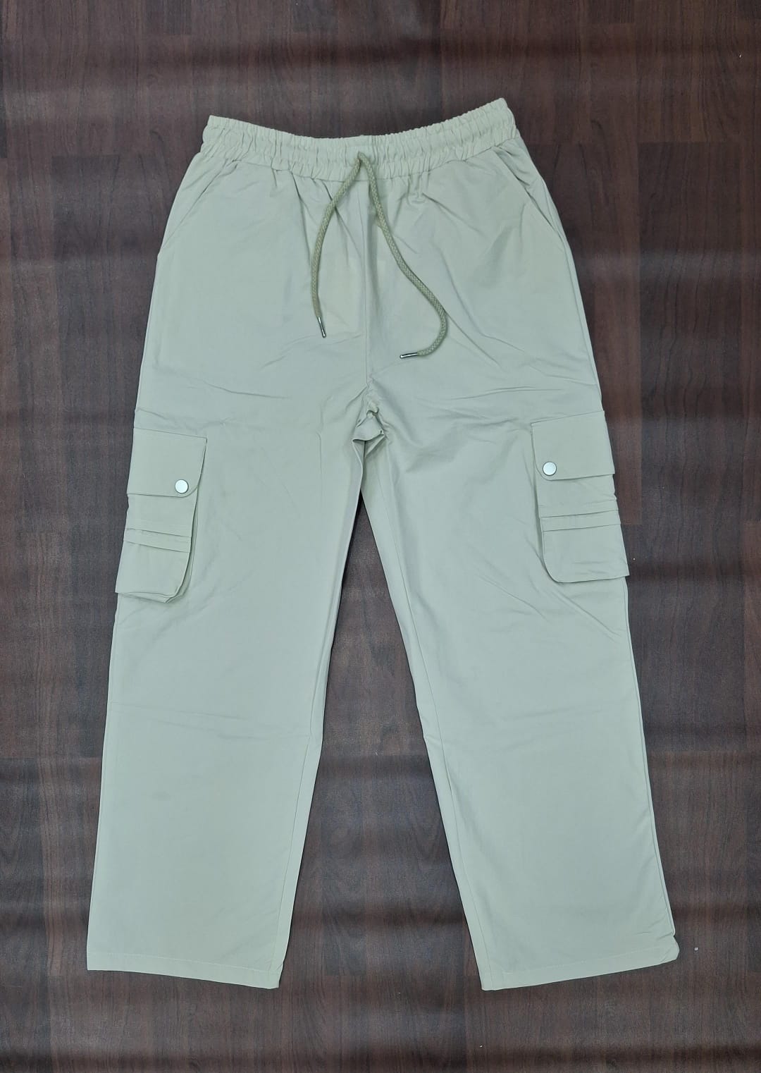 Sage green relaxed-fit cargo pants with elasticated drawstring waist and flap cargo pockets
