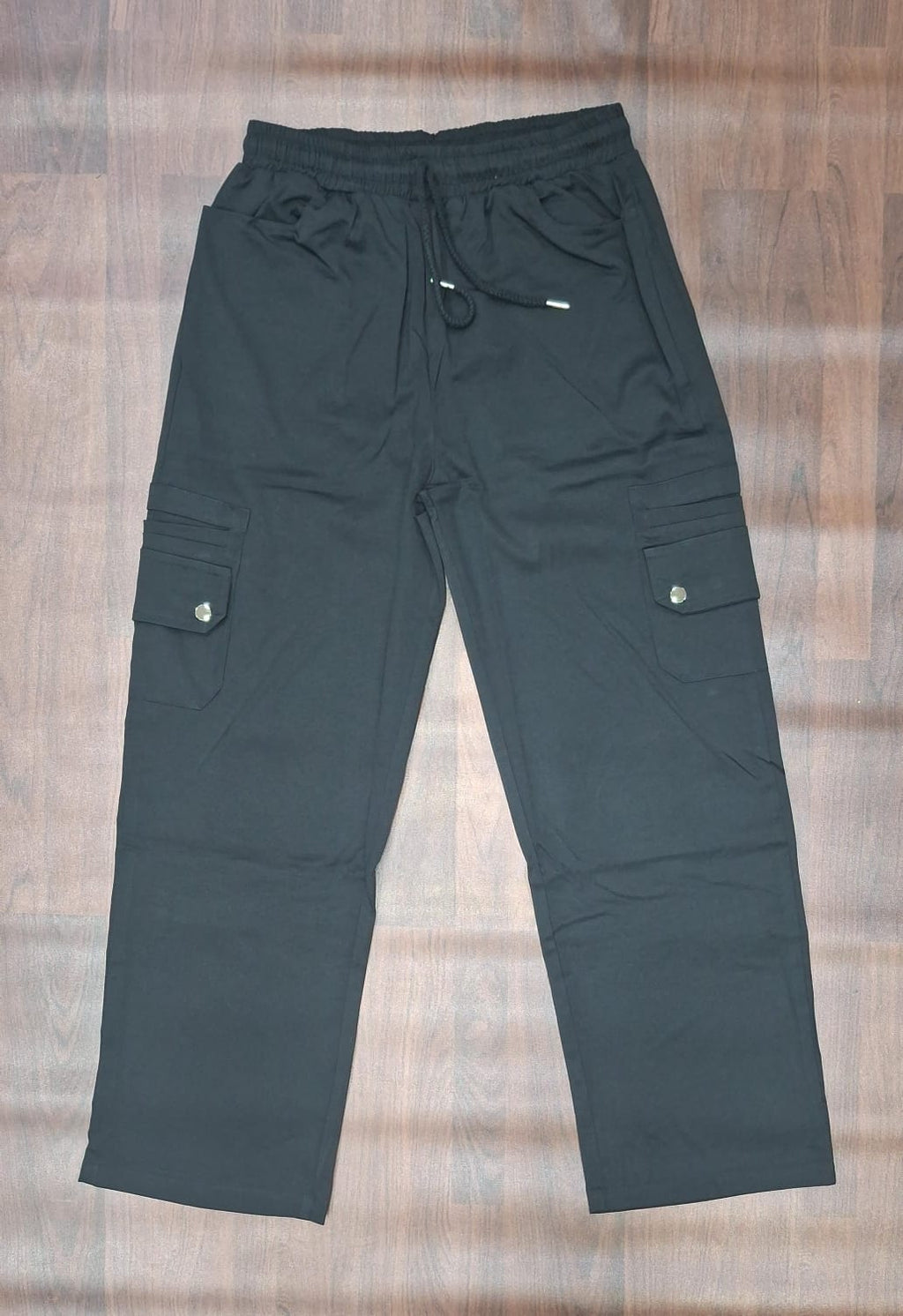 Light green cargo pants with elasticated waistband and utility pockets