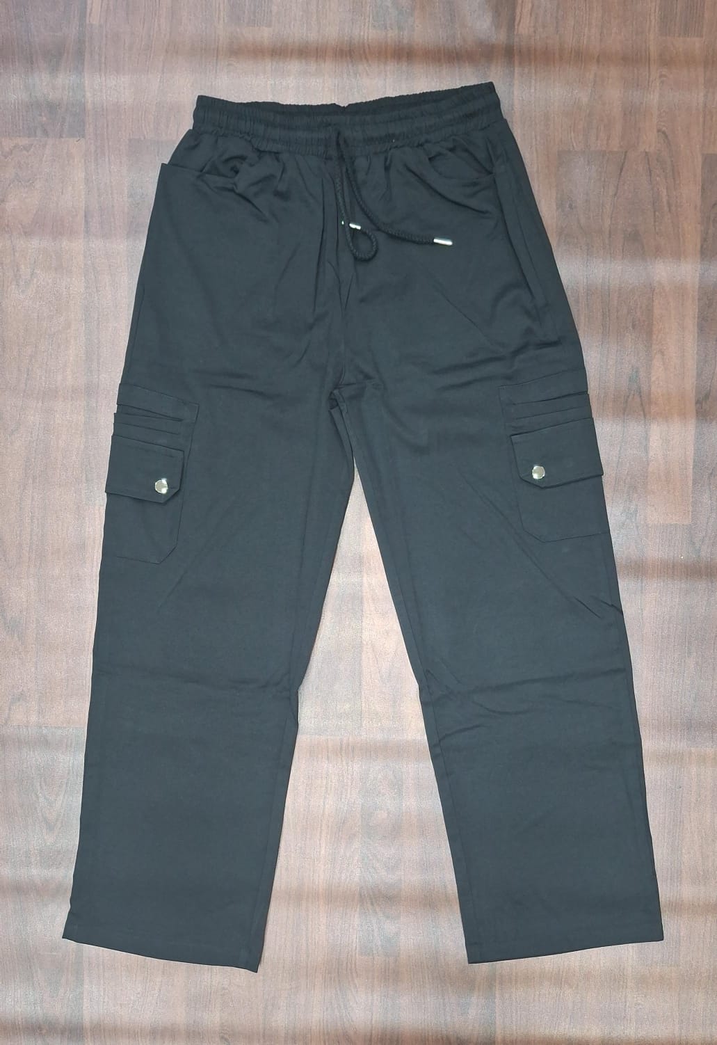 Light green cargo pants with elasticated waistband and utility pockets