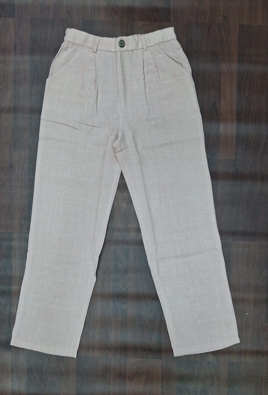 Beige textured straight-leg trousers with front pleats and angled pockets