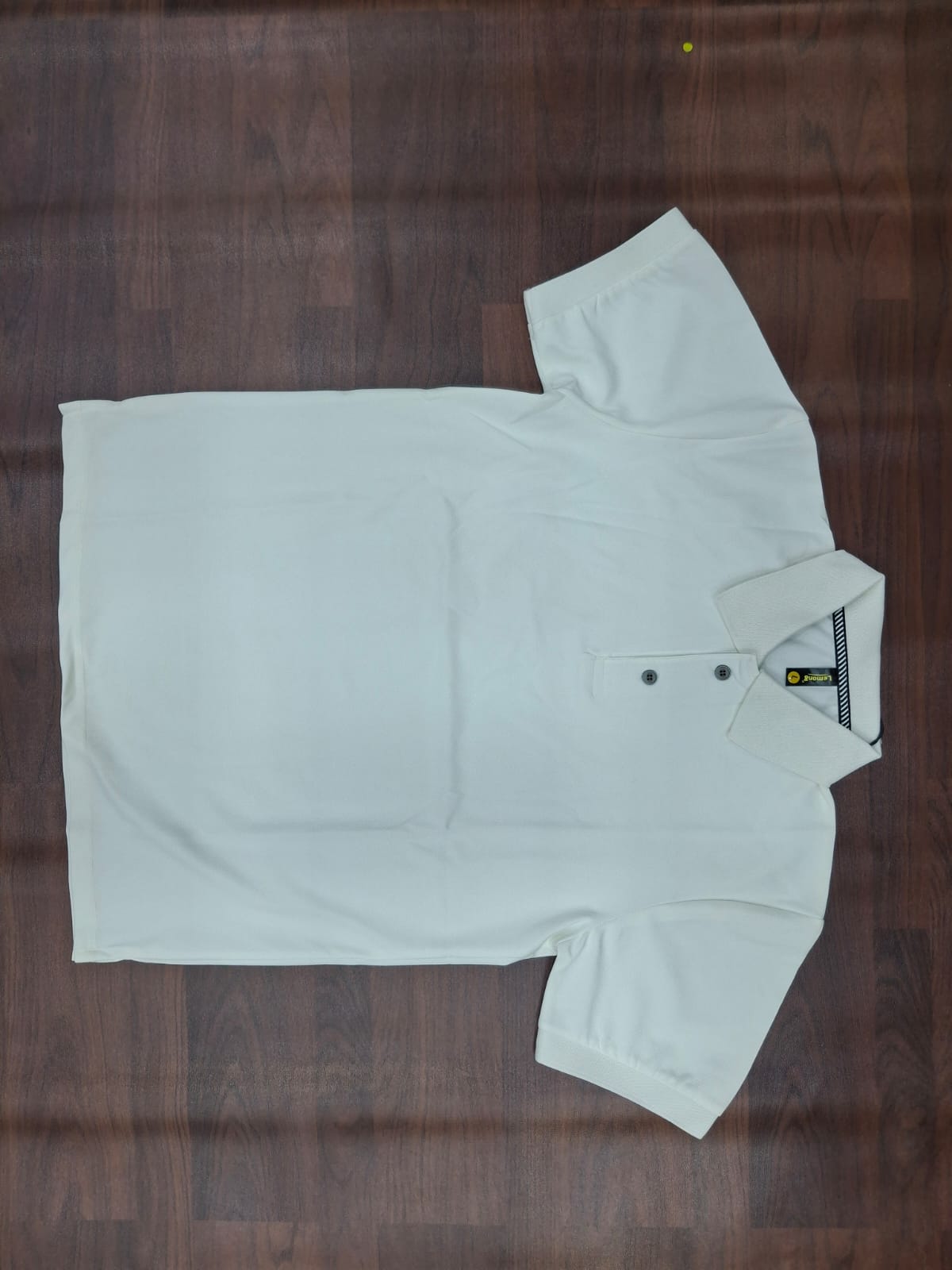 White solid half-sleeve polo T-shirt with structured collar, two-button placket, and contrast trim