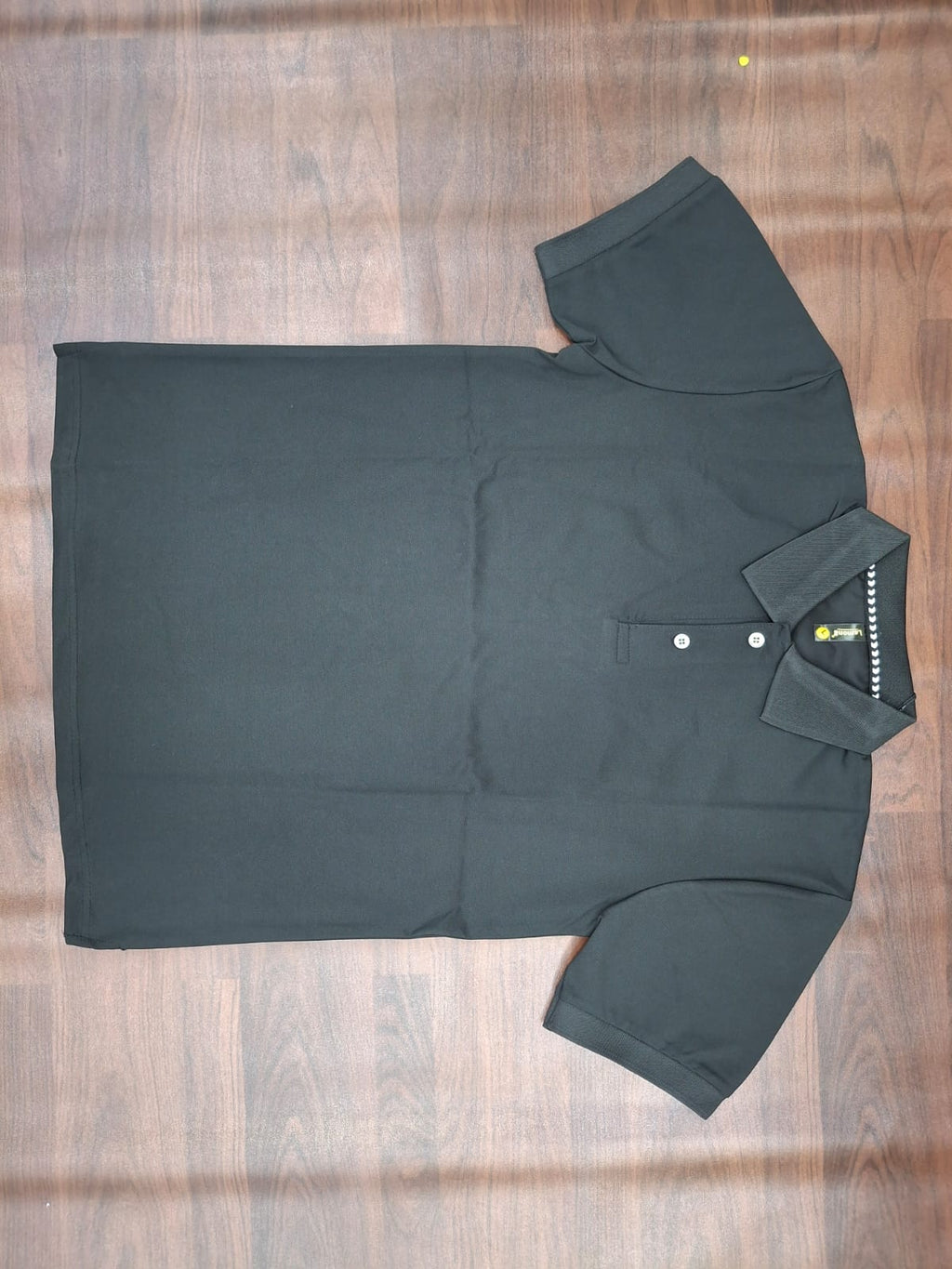 Black solid half-sleeve polo T-shirt with structured collar, two-button placket, and contrast trim