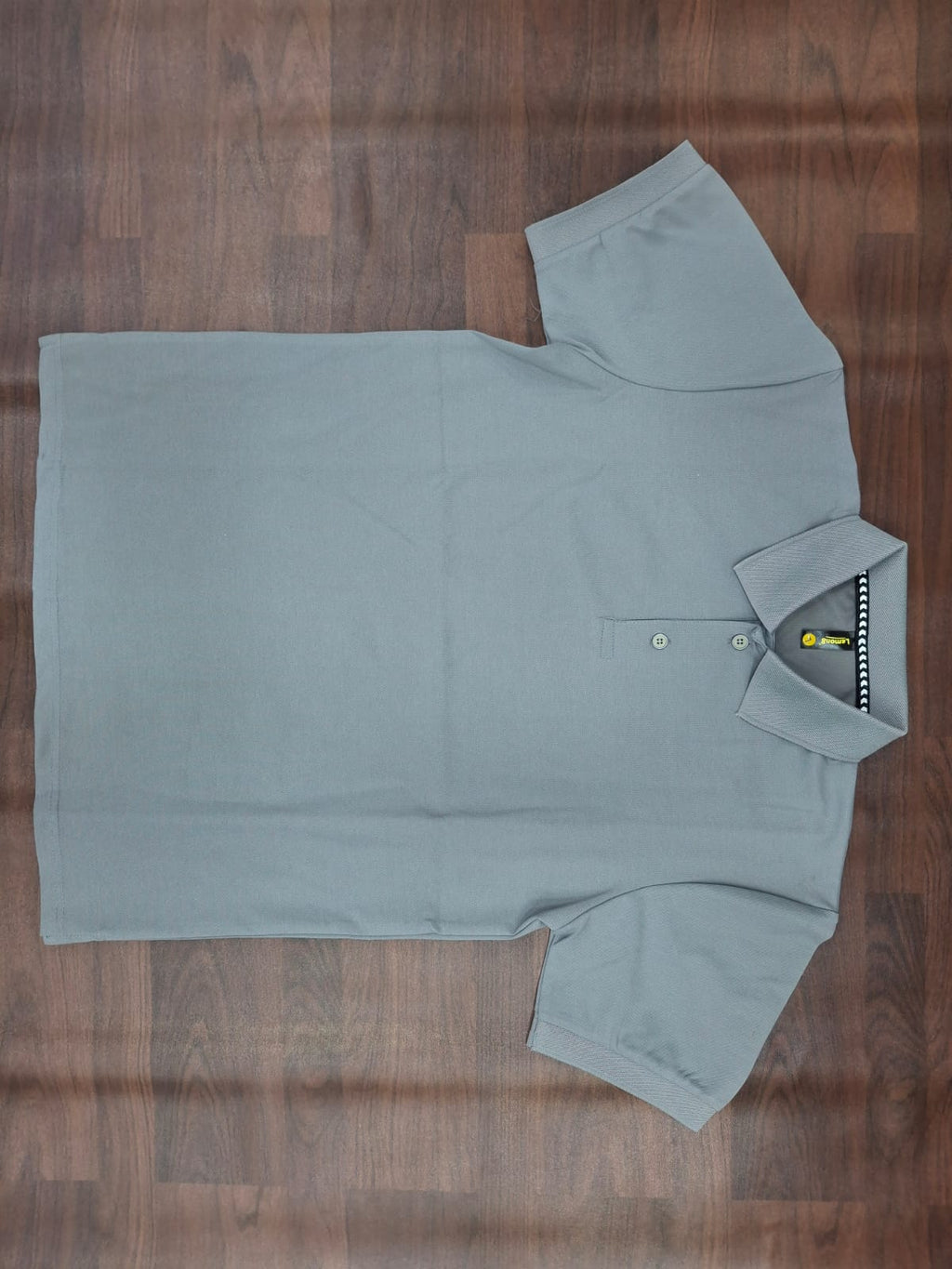 Beige solid half-sleeve polo T-shirt with structured collar, two-button placket, and contrast trim